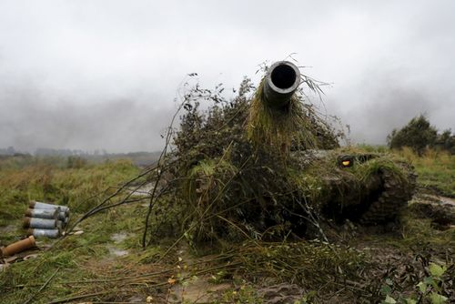  A tank is hidden during a military exercise at a training ground near Kaliningrad, Russia, last year. Picture: AP