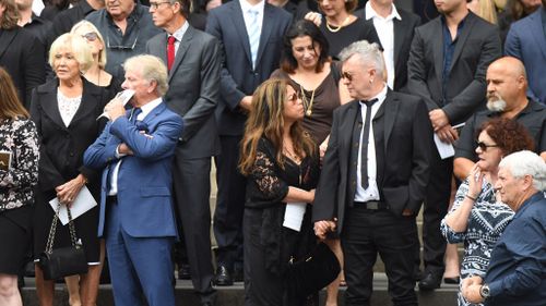 Jimmy Barnes and his wife Jane join family, friends and fellow musicians of AC/DC co-founder and guitarist Malcolm Young during his funeral at St Mary's Cathedral (Image: AAP)