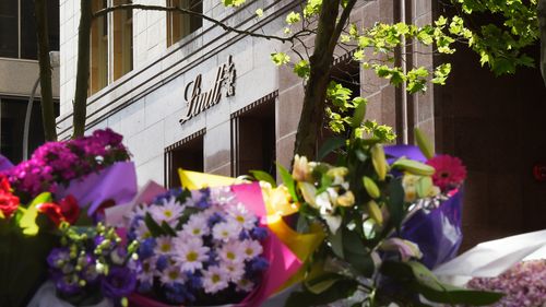 Martin Place was flooded in a sea of colour as people shared in their grief for the victims and hostages of the Lindt cafe siege. (AAP)