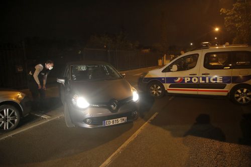 Police officers block the access after a history teacher who opened a discussion with students on caricatures of Islam's Prophet Muhammad was decapitated in a French street on Friday and police have shot the suspected killer dead, Friday, Oct. 16, 2020 in Conflans-Saint-Honorine, north of Paris. (AP Photo/Michel Euler)