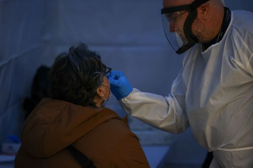 A woman is getting a Covid-19 test at a Covid-19 testing hub in the Penn Station of New York.