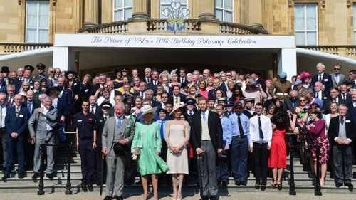 Prince Charles, Camilla, Meghan and Prince Harry pose with the guests. (PA/AAP)