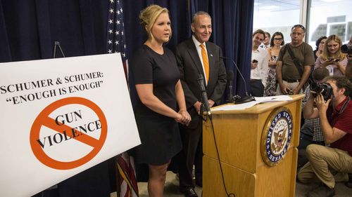 Amy Schumer and Sen. Chuck Schumer (D-NY) appeared today at a press conference in NYC to announce a three-part legislative gun control plan. Source: AFP