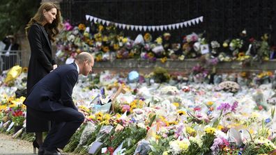 William, Prince of Wales, foreground and Kate, Princess of Wales, look at floral tributes left by members of the public, in memory of late Queen Elizabeth II, at the Sandringham Estate, in Norfolk, England, Thursday, Sept. 15, 2022.   