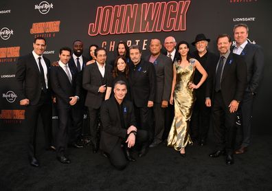 Marko Zaror, Scott Adkins, Shamier Anderson, Rina Sawayama, Hiroyuki Sanada, Keanu Reeves, Erica Lee, Laurence Fishburne, Joe Drake, Natalia Tena, Clancy Brown, David Leitch, Basil Iwanyk and Chad Stahelski (kneeling) attend John Wick: Chapter 4 Los Angeles Premiere at TCL Chinese Theatre on March 20, 2023