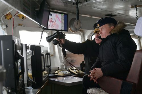 Russian President Vladimir Putin watches the joint drills by the Northern and Black Sea Fleets from onboard the cruiser Marshal Ustinov in the Black Sea off the coast of Crimea on January 9, 2020