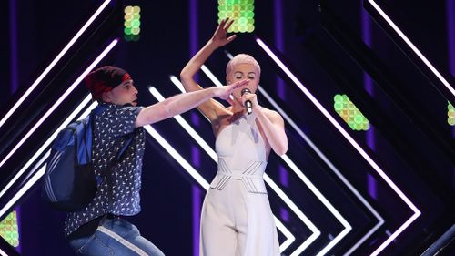 A protester has stormed the stage during the 63rd Eurovision Song Contest, interrupting a performance by UK singer SuRie to "demand freedom" in Lisbon's Altice Arena last night. (Picture: EPA)