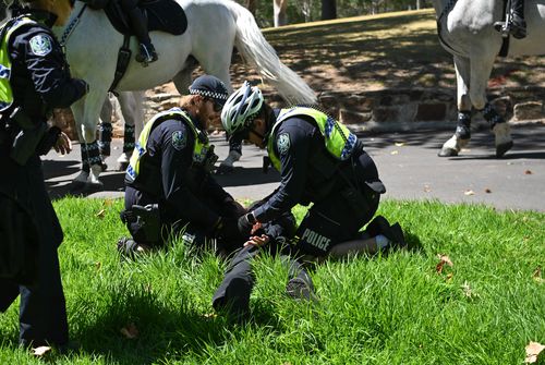 ADELAIDE, AUSTRALIA - JANUARY 26: Members of the National Socialist Network (NSN) are arrested as they hold in the East2 Parklands a counter protest on North Terrace on January 26, 2025 in Adelaide, Australia. Australia Day, formerly known as Foundation Day, is the official national day of Australia and is celebrated annually on January 26 to commemorate the arrival of the First Fleet to Sydney in 1788. Many indigenous Australians refer to the day as 'Invasion Day' and there is a small but growi