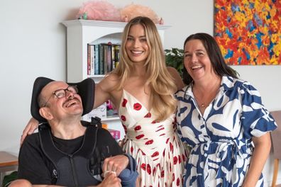 Margot Robbie smiles during her visit with Brian (left) and Tash (right).