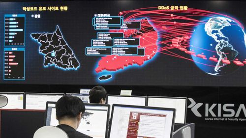 Employees look at electronic whiteboards to monitor possible ransomware cyberattacks at the Korea Internet and Security Agency in Seoul, South Korea.