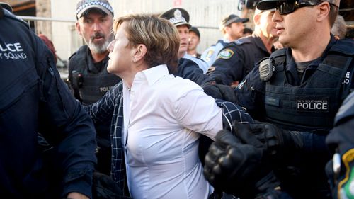 Christine Forster's jacket was ripped off in the ensuing chaos. (AAP)