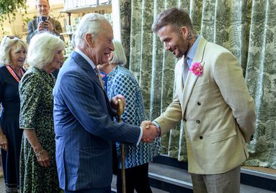 David Beckham, wearing the King's Rose, with King Charles and Queen Camilla during a visit to the Chelsea Flower Show on Monday May 19, 2025.