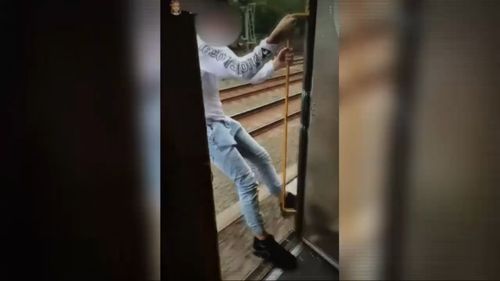 The teens filmed themselves hanging out of the open doors of train carriages. (9NEWS)