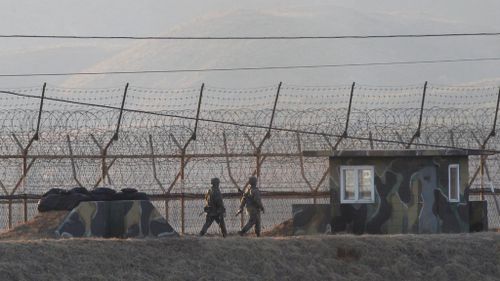 South Korean army soldiers patrolled a barbed-wire fence near the border with North Korea on the day of the launch. (AAP)