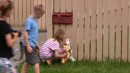 Children have laid flowers and a toy outside the home. (9NEWS)