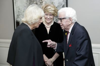 Camilla, Duchess of Cornwall (L) speaks with Barry Cryer (R) as she attends a reception hosted by Gyles Brandreth, President of the Oscar Wilde Society, to mark the anniversary of the author's birth at the Grosvenor House London on October 15, 2019 