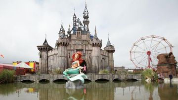 Mysterious British artist Banksy has unveiled his biggest work to date – a creepy “bemusement park” called Dismaland.<br><br>Featuring pieces by the man himself and other contemporaries, the new theme park exhibition was built in an abandoned beachside area in Western-super-Mare in Somerset, England.<br><br><strong>Click through to see inside the confronting show.</strong>