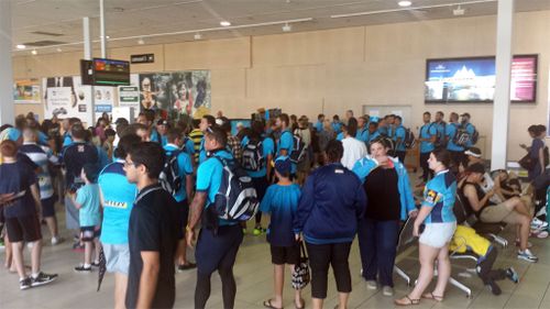 The Gold Coast Titan arrive at the Gold Coast airport following an NRL trial in Cairns. (AAP)