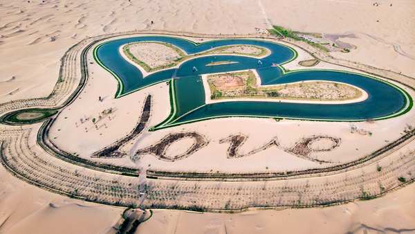 Heart shape man made lakes in the middle of Dubai desert in Al Qudra area aerial view