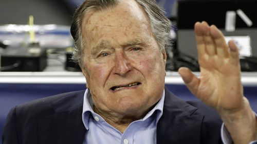 Former US president of the USA George HW Bush at a sports game