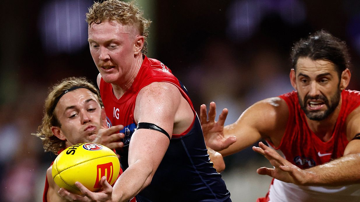 Clayton Oliver of the Demons is tackled by James Rowbottom (left) and Brodie Grundy of the Swans during the 2024 AFL Opening Round match between the Sydney Swans and the Melbourne Demons at the Sydney Cricket Ground on March 07, 2024 in Sydney, Australia. (Photo by Michael Willson/AFL Photos via Getty Images)