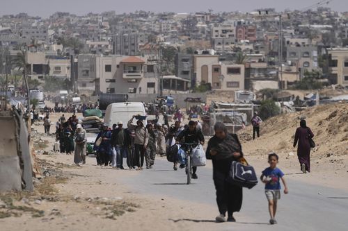 Displaced Palestinians flee from Khan Younis, Gaza, amid the ongoing Israeli military offensive in the area, on Monday, May 19, 2025. (AP Photo/Abdel Kareem Hana)