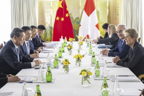 Chinese Vice Premier He Lifeng, left, Switzerland's Economy Minister Federal Councillor Guy Parmelin, center, Switzerland's President Karin Keller-Sutter, right,