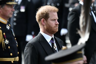 Prince Harry, Duke of Sussex, follows the coffin of Queen Elizabeth II, draped in the Royal Standard, on the State Gun Carriage of the Royal Navy, as it travels from Westminster Abbey to Wellington Arch on September 19, 2022 in London, England. 