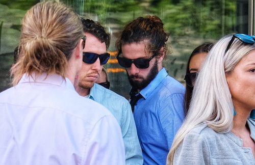 Alexander Wells, (centre, with beard) aged 21, is seen outside of the County Court of Victoria. (AAP)
