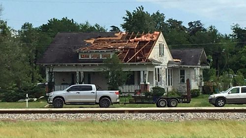 A roof is torn off a home following a suspected tornado in Franklin, Texas.