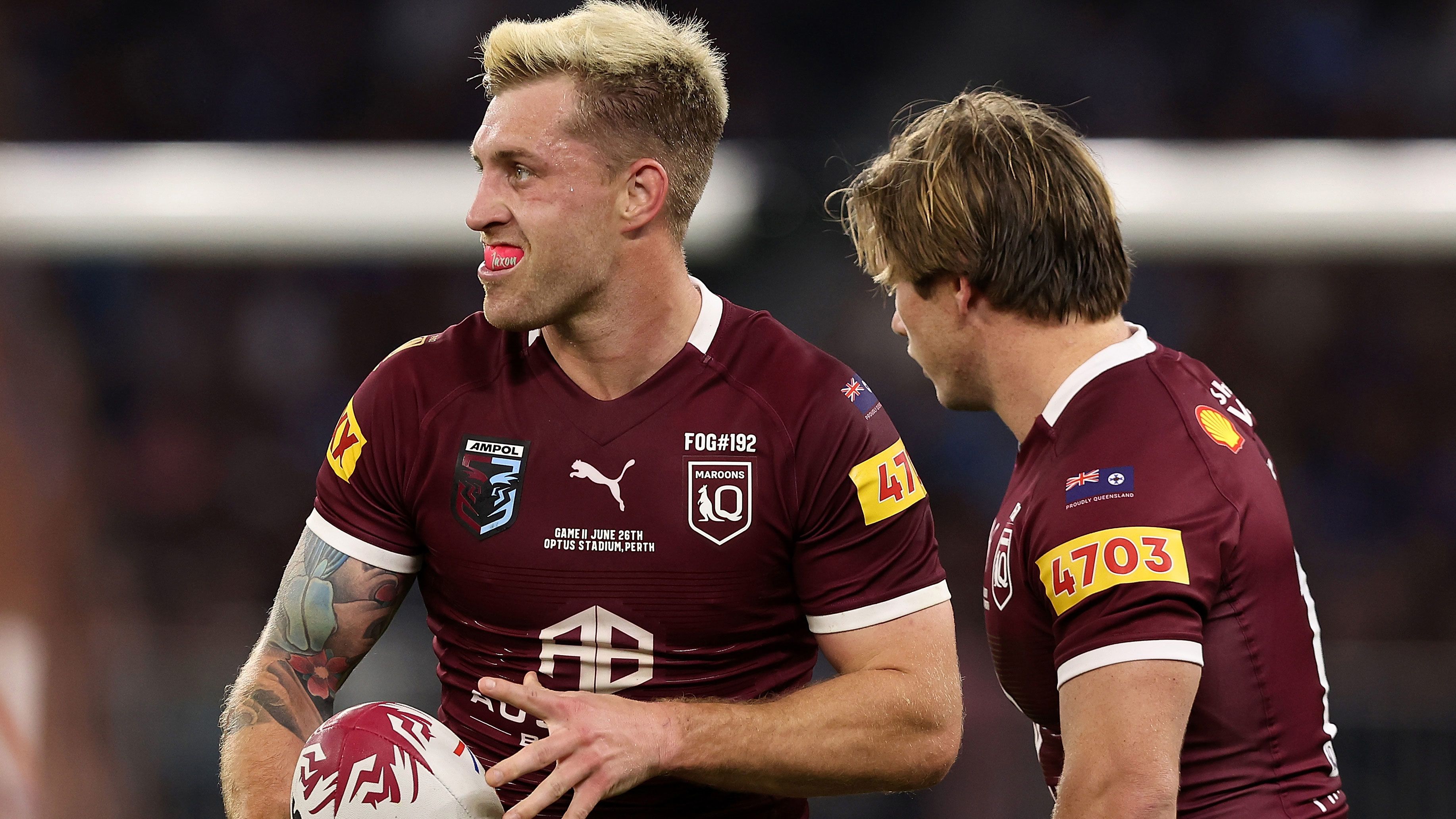 Cameron Munster in action for the Maroons as Harry Grant looks on.