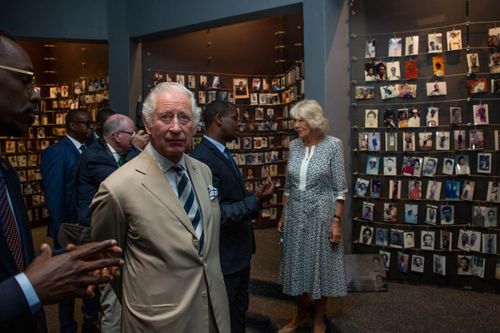 Britain's Prince Charles and Camilla, Duchess of Cornwall, observe an exhibition of family photographs of some of those who died, at the Kigali Genocide Memorial in the capital Kigali, Rwanda Wednesday, June 22, 2022. 
