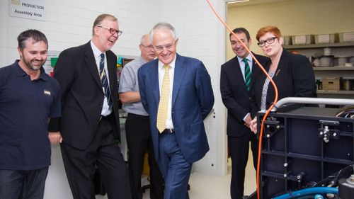 Mr Turnbull shares a laugh with managing director of Furgo LADS Corporation Mark Sinclair during a tour of the facility in Adelaide. (AAP)