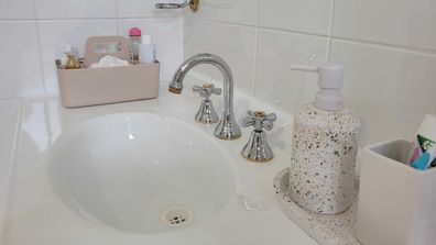 Kmart art and craft caddy used as a skincare organiser on bathroom vanity, which can be removed and put in the cabinet below