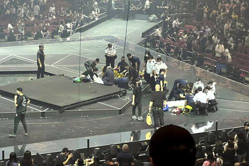 Two dancers receive medical treatment at a concert of Cantopop boy band Mirror in Hong Kong, Thursday, July 28, 2022. 