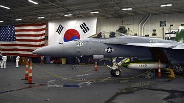 An F-18 fighter aircraft sits in the hanger of the Theodore Roosevelt (CVN 71), a nuclear-powered aircraft carrier, anchored in Busan Naval Base in Busan, South Korea Saturday, June 22, 2024.