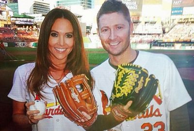 <b>Michael and Kyly Clarke have shared an historic moment in the United States after being invited to throw the first pitch at a Major League Baseball game.</b><br/><br/>The couple was invited to take part in the ceremony at the match between St Louis Cardinals and Chicago Cubs at Busch Stadium and stunned onlookers when they took up their positions.<br/><br/>Instead of striding to the mound, Australia's cricket captain instead played the role of catcher behind home plate, leaving the real honour of throwing the first pitch to Kyly.<br/><br/>