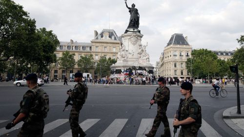 French soldiers walk past the place de la Republique's monument in Paris. (AFP)