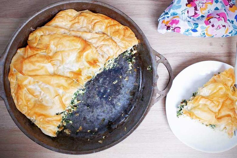 A spinach pie in a pan makes the perfect lazy dinner that still looks so good