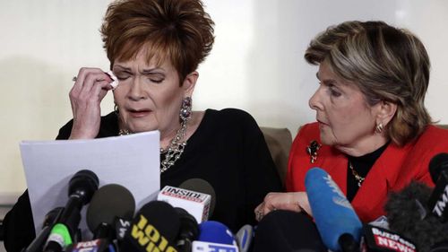 Beverly Young Nelson is comforted by lawyer Gloria Allred. (AAP)