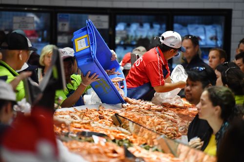 Fishmongers sell prawns by the bucketful on Christmas Day. 
