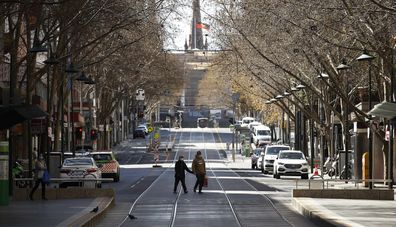 A woman is seen exercising along a quiet Bourke Street on September 06, 2020 in Melbourne, Australia. 