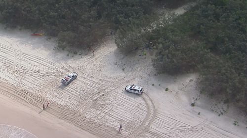 A man is fighting for life after he fell into a hole and was buried by sand on the northern end of Bribie Island in Queensland.