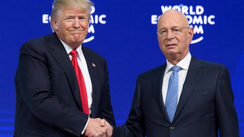 Donald Trump shakes hands with German Klaus Schwab, Founder and Executive Chairman of the World Economic Forum. (AAP)