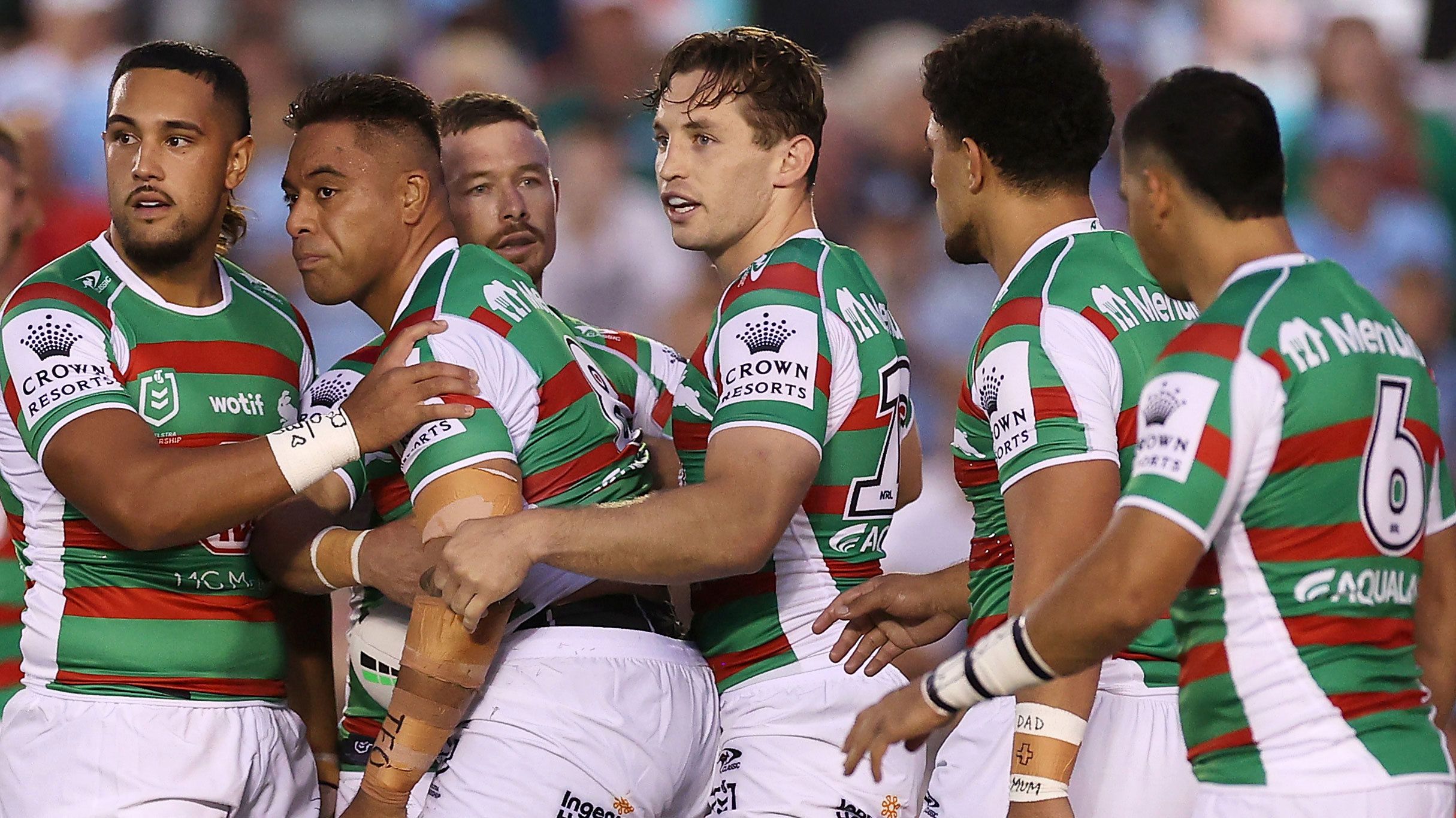 Tevita Tatola of the Rabbitohs is supported by his team after a head knock against the Sharks.