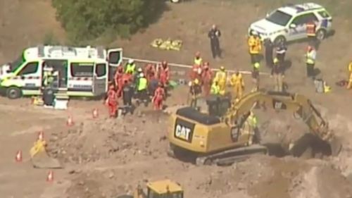 Excavators worked for more than two hours to free the trapped worker. (9NEWS)