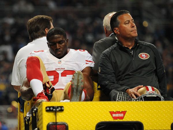 Reggie Bush is carted off the field after suffering an injury. (AFP)