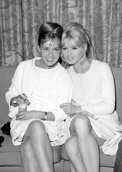 Jeanne Moreau with Brigitte Bardot in the Air France lounge at Kennedy Airport, 1965.