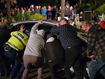 Crowd lifts car out of the way of Anzac ceremony in New Plymouth New Zealand