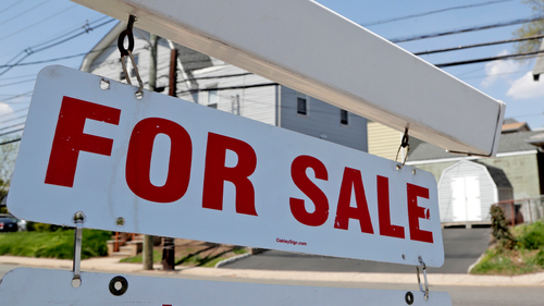  A "for sale" sign hangs from a post outside of a vacant business building in Belleville, N.J., Thursday, May 3, 2018. 